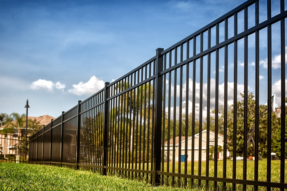 A black metal fence with a modern design is an attractive and secure option for properties of all types.
