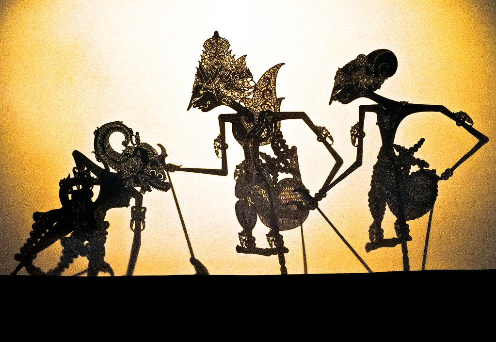 An image of three intricately designed Javanese shadow puppets made of leather, depicting a scene from the Ramayana Hindu epic.
