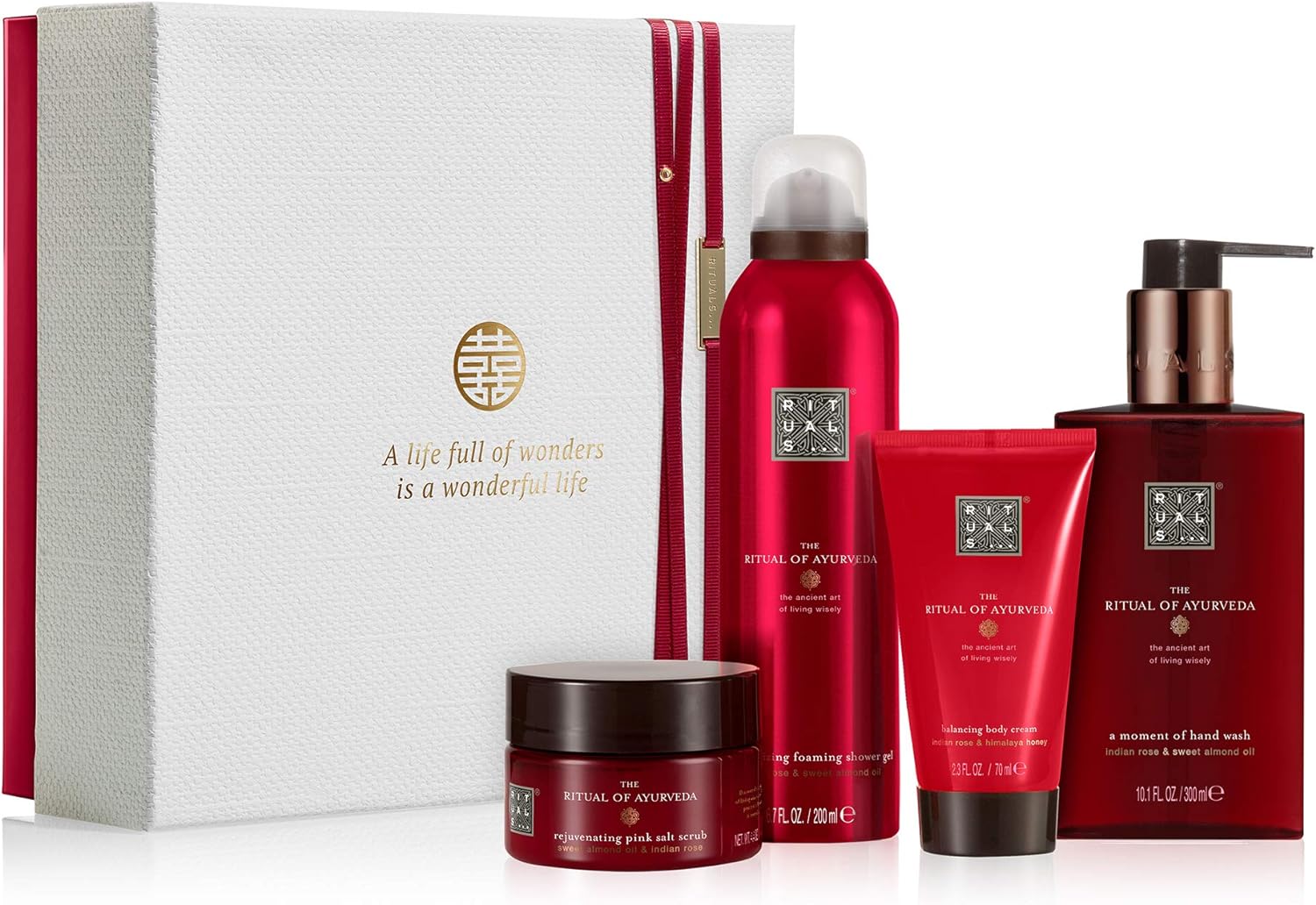 A photo of a gift set of Rituals products with a red background. The text on the box reads: 'A life full of wonders is a wonderful life'. The products in the set include a foaming shower gel, a body scrub, a hand wash, and a body cream.