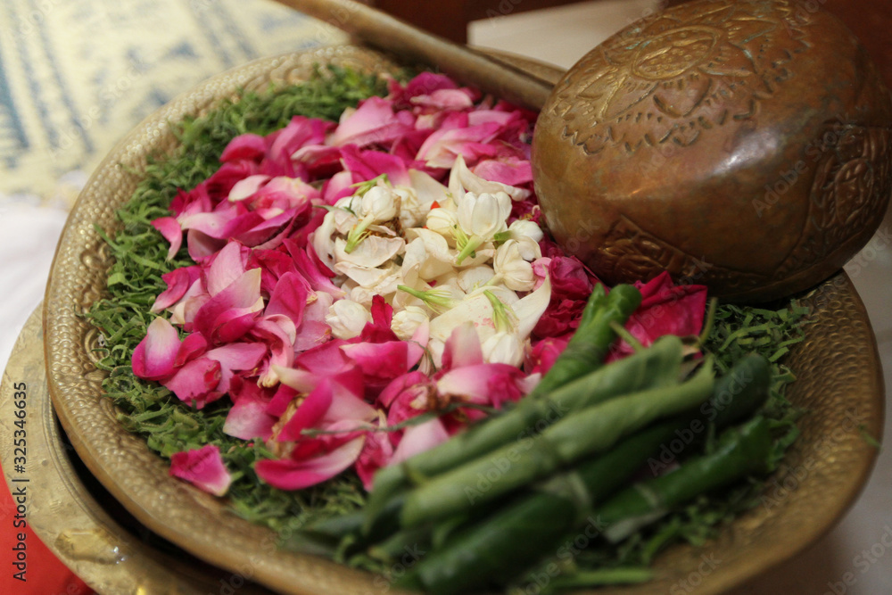 A picture of a Love spell ingredients like jasmine flower betel leaf rose water incense and essential oil