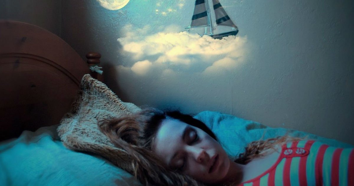 A young woman is sleeping in her bed and dreaming about a deceased loved one who is alive in the dream and they are both sailing on a boat in the sky.