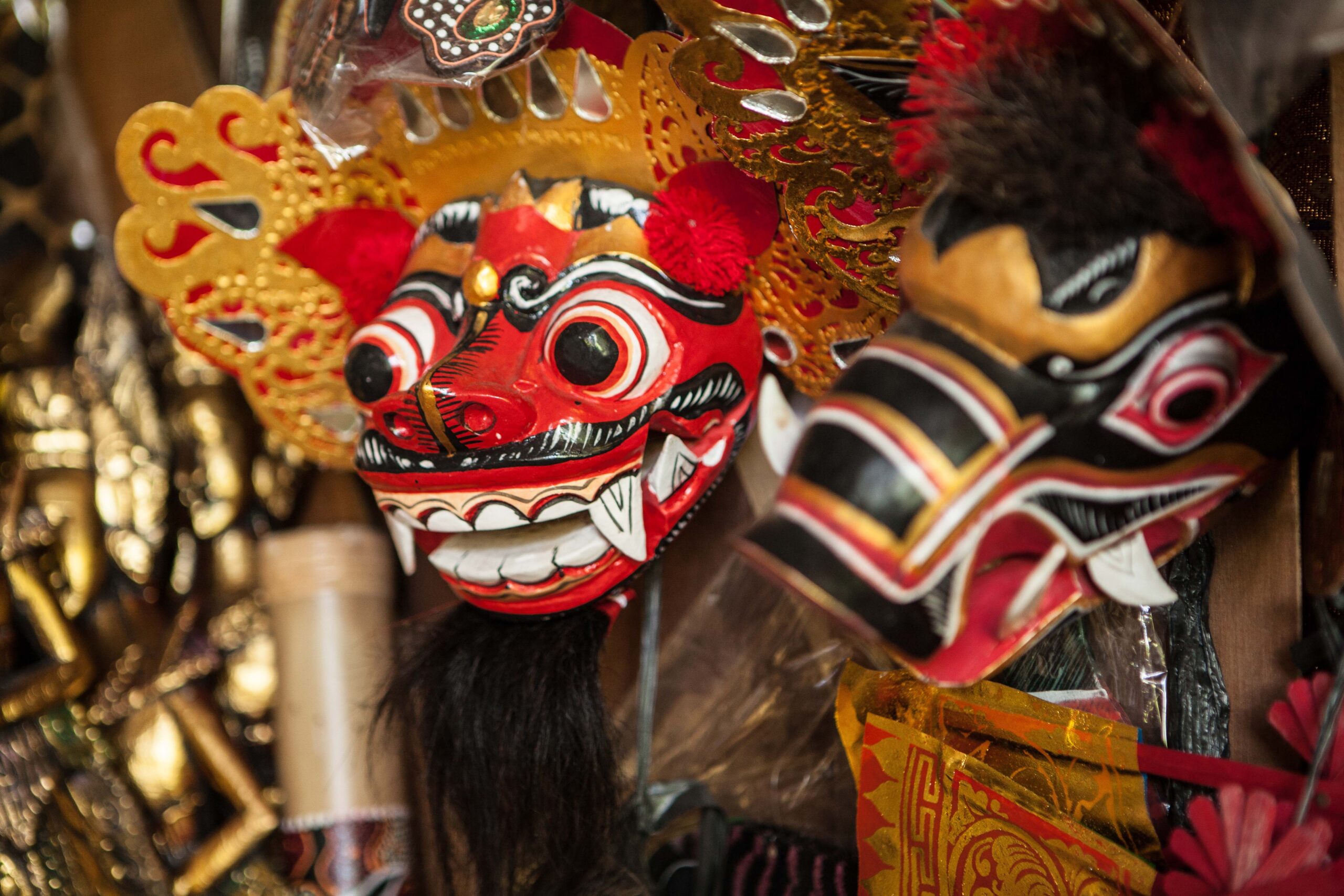 A red and black Barong mask, a mythical creature in Indonesian culture considered a guardian of the village.