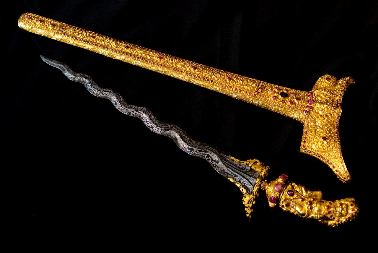 A golden keris with a black handle, with a golden sheath decorated with red gemstones, is considered an heirloom that brings bad luck in Indonesian culture.