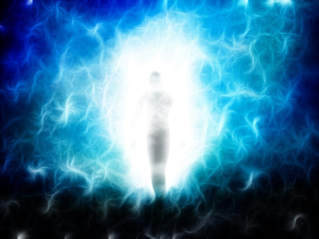 A blue glowing aura surrounds the outline of a person.